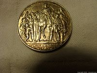 Reverse side of 1913 Deutsches Reich 2 Mark coin depicting a man on horseback surrounded by people with German inscription beneath.