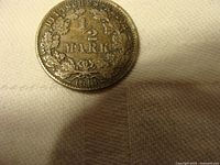 Photo of one 1918 German Empire 1/2 Mark silver coin face showing the denomination and date with wreath decoration.