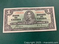 Front side of the 1937 Bank of Canada one dollar bill showing King George VI portrait, serial numbers, and signatures.