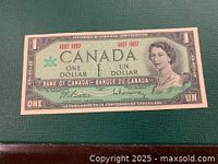 Front side of the 1967 Canadian Centennial one dollar bill showing Queen Elizabeth II and denomination details.
