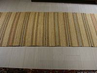 Full view of the jute runner showing its length and striped design on a light wood floor.