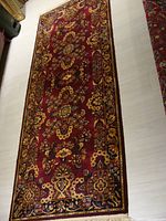 Full view of Karastan handwoven wool runner rug showing entire length and detailed floral edge.