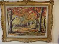 Full view of framed oil painting showing tree landscape with autumn colors and decorative gold frame.