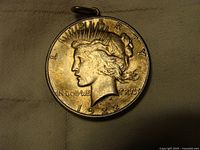 Obverse side of the 1922 US Peace Dollar pendant showing Lady Liberty profile, date 1922 and inscriptions.