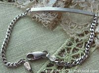 Photo of vintage sterling silver bracelet showing slightly curved plaque, curb link chain, lobster clasp marked Italy 925.