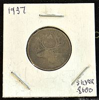 Obverse of 1937 Canadian 25 cents silver coin showing caribou design.