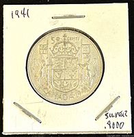 Reverse side showing the Canadian coat of arms, '50 CENTS' and 'CANADA' inscriptions, labeled '1941' on white paper holder.