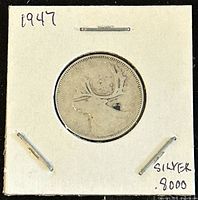 Front side of the 1947 Canadian 25 cents coin showing the caribou design.