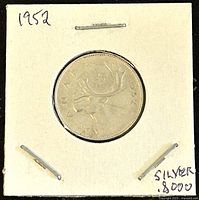 Front view of the 1952 Canadian 25 cent coin in holder showing caribou design and year 1952.