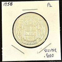 Reverse side showing Canadian coat of arms with unicorn and lion, crown, shield design and 'CANADA 1958' inscription.