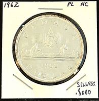 Front side of the 1962 Canadian silver one dollar coin with canoe design and inscriptions CANADA, 1962, DOLLAR.