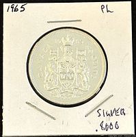 Obverse side showing the 1965 Canadian 50 cent coin with the Canadian coat of arms and 80% silver notation.