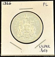 Obverse side of the 1966 Canadian 50 cents coin showing the coat of arms and date.