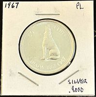 Obverse side showing howling wolf, '50 CENTS', 'CANADA 1847-1967', and provenance markings including 'silver .800'.