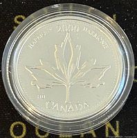 Reverse side of 2000 Canadian silver proof 25 cent coin with maple leaf design, year 2000, 'Harmony' inscription and Canada inscription.
