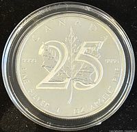 Reverse side of the 2013 Silver Maple Leaf 25th Anniversary coin displaying maple leaf with large '25' marking the anniversary.