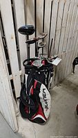 Full view of left-handed golf clubs in TaylorMade Burner bag showing woods, irons and driver