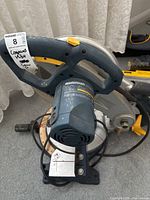 Close-up of the handle and main body of the Mastercraft mitre saw showing the ergonomic grip and part of the base.