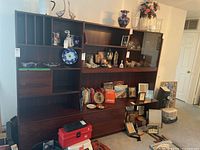 Full front view of the two-section cabinet showing glass doors, open shelves and sliding doors