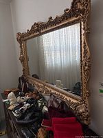 Overall view of large rectangular mirror leaning against wall