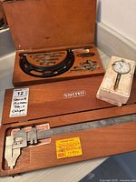 Full contents of three tools with their original boxes: Starrett micrometer, Starrett caliper, and Teclock dial indicator box.