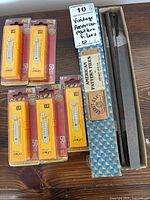Full view of the lot showing three vintage American Pattern files in original box and five unopened packages of Olfa Pro 18mm snap off blades.