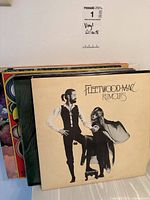 Vinyl records viewed from side, showing thickness and condition, with label indicating lot number and category as Vinyl Records.