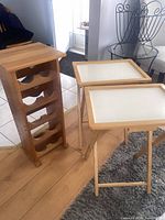 Photo showing full view of wooden wine rack and two small folding tables, illustrating their size and condition.