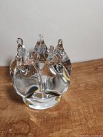 Clear glass Goran Warff candlestick holder showing organic sculptural form and polished base with gold foil spots.