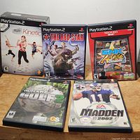 All five games shown together including EyeToy Kinetic box and the four other game cases: The Red Star, NeoGeo SNK Arcade Classics Vol. 1, Outlaw Golf 2, and Madden NFL 2002.