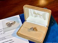 Ring in Mappins box alongside appraisal documents visible