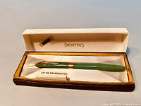 Full view of celadon green Sheaffer's fountain pen in original box with instruction pad