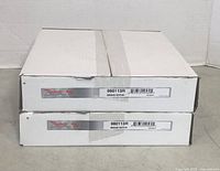 Two Raybestos brake rotors in original boxes stacked one on top of the other, labels visible showing model 980113R and marked as brake rotors.