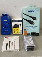 Full lot view showing all 5 items including Onn HDMI cable, audio kit, multiport hub, Scoschel Type-C to Lightning cable, and black USB adaptor