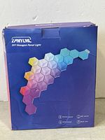 Box front showing brand, product name, and example of hexagon light panels in a rainbow gradient.