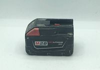 Side view of Milwaukee M28 RedLithium XC battery showing model label and condition.