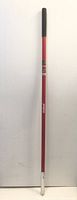 Full length view of red fibreglass handle with black grip and metal ferrule at end