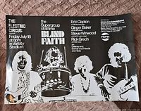Photo of a black and white Blind Faith concert poster laid on a textured surface