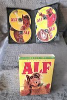 Complete ALF Season 2 DVD set with all four discs inside open case and the box in front showing the ALF character.