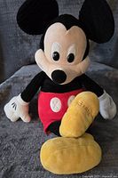 Front view of Mickey Mouse Scentsy Buddy plush showing black ears, white gloves, red shorts, and yellow feet.