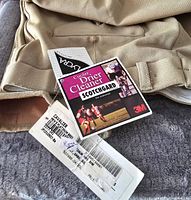 Close up of tags showing brand Cavalier, size 8, Scotchgarde protection label, and original new condition