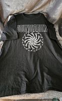 Black men's T-shirt featuring Soundgarden band name and circular graphic on the front, size Large/XL.