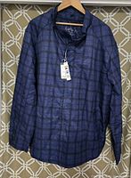 Front view of men's light jacket showing blue with black checkered pattern, full zipper, and pockets