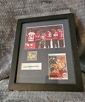 Framed display showing signed hockey card, Montreal Canadiens pin, and 'Guy Carbonneau' name plate.