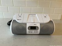 Front view of white HANNLOMAX HX-318CD boombox, showing speakers, display, and buttons on front panel