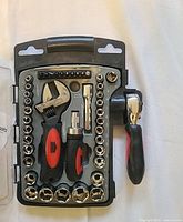 Photo of the opened tool and socket set showing all included pieces inside carrying case arranged neatly.