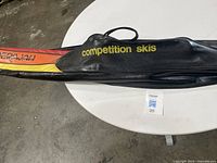 Black protective bag with 'competition skis' and Maherajah branding on a white round table.