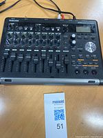 Top view showing eight channel faders, knobs, buttons and LCD screen