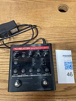 Front view of TC Helicon Harmony G-XT with DC power adapter