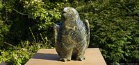 Front view of the green serpentine owl sculpture on wooden base